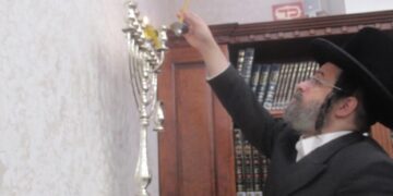 הסופר דוד דמן כובד להדליק את הנרות בביהמ”ד בעלזא